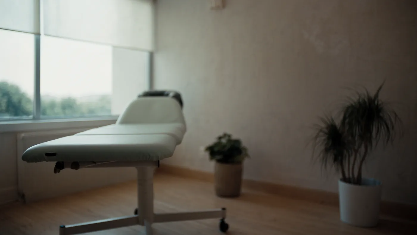 A calm modern chiropractic treatment room with soft daylight