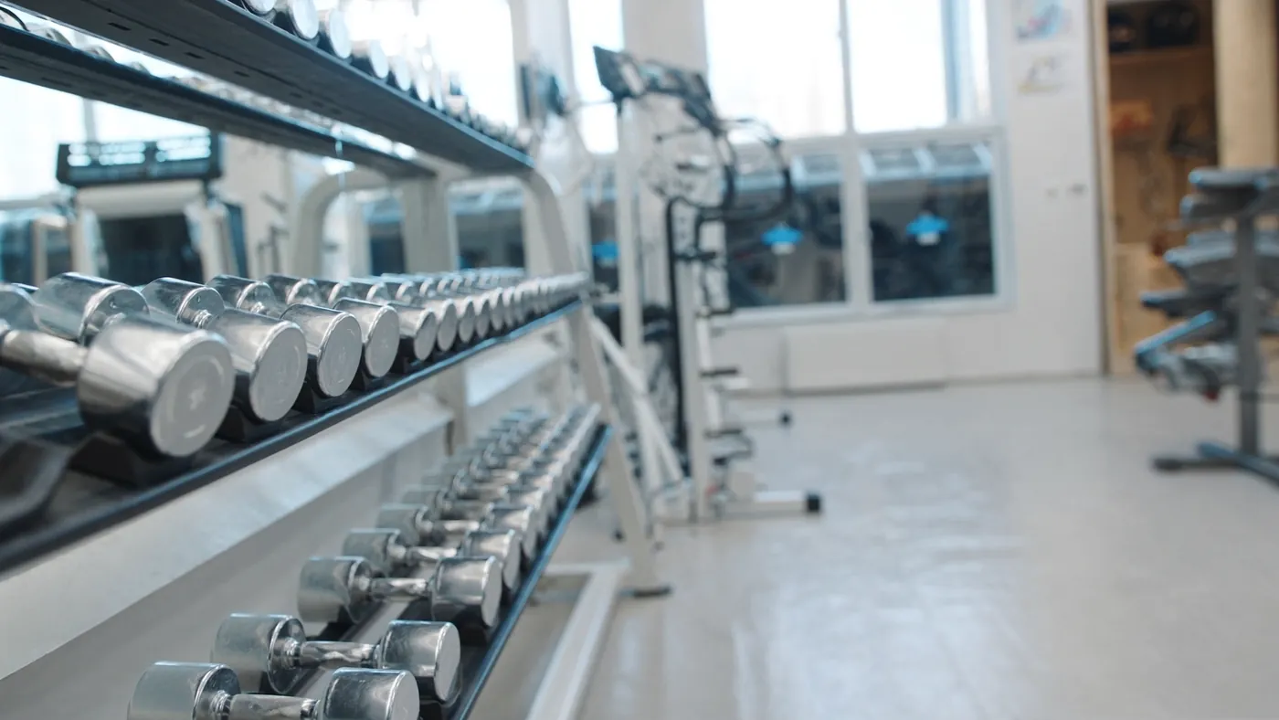 A modern fitness studio with clean equipment and bright windows