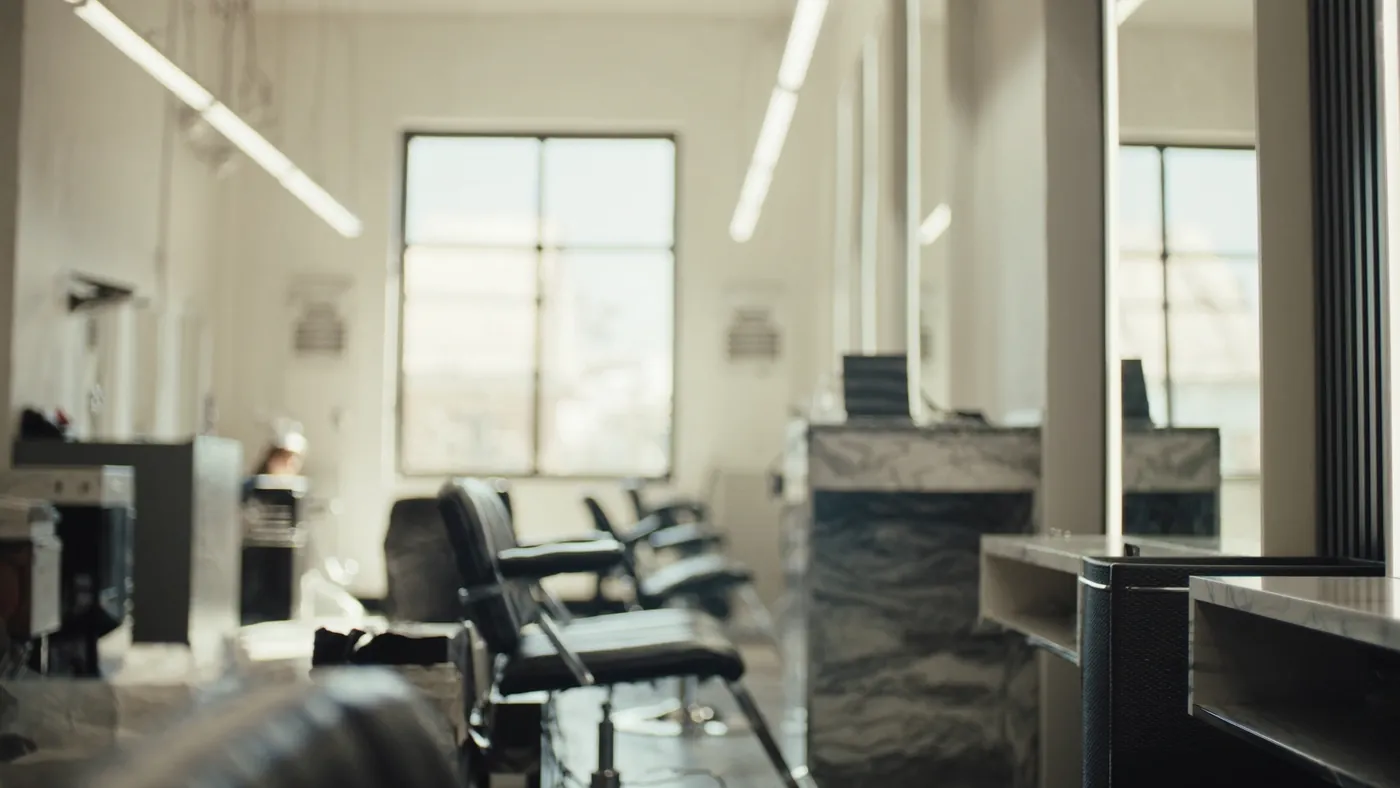 A stylish modern salon and barbershop with clean chairs at mirrors